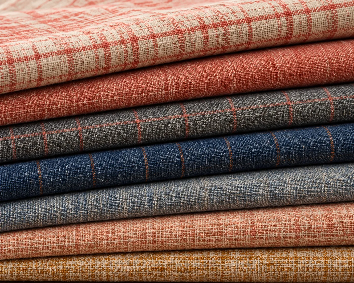 Stack of folded striped cotton fabrics in red, grey and blue